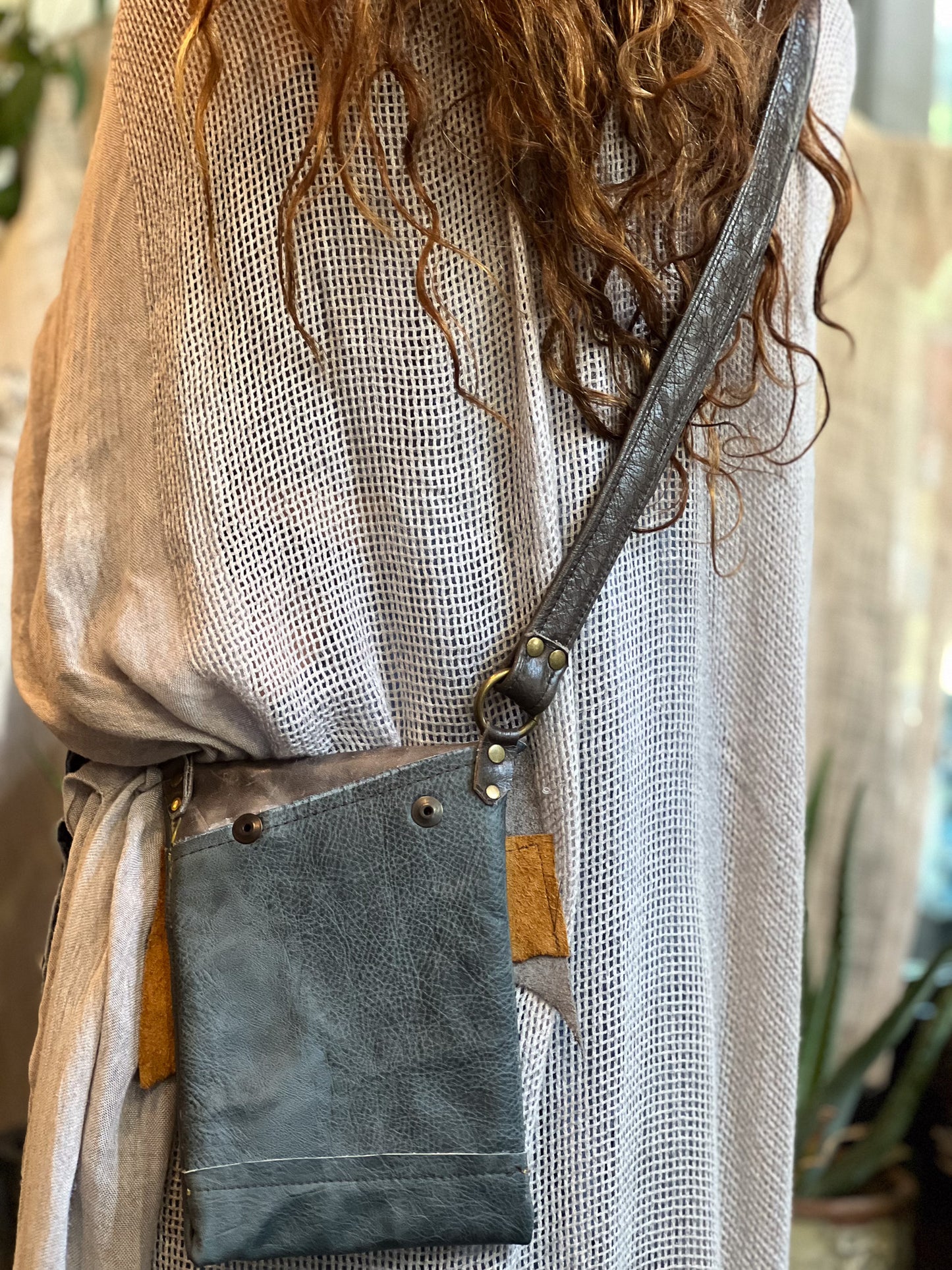 Person wearing a textured garment with a crossbody bag