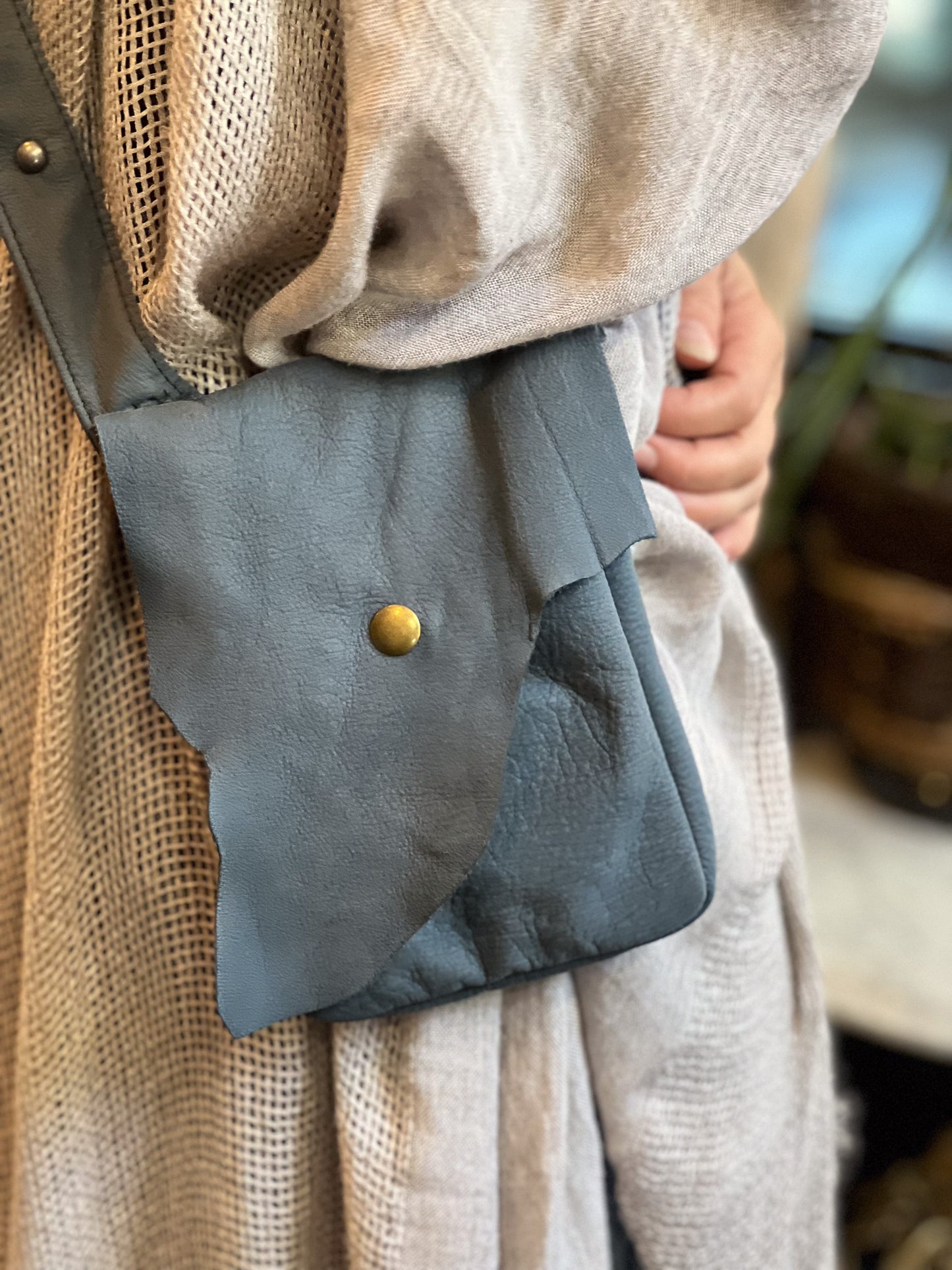 close up of holster pocket with antique brass snap closure