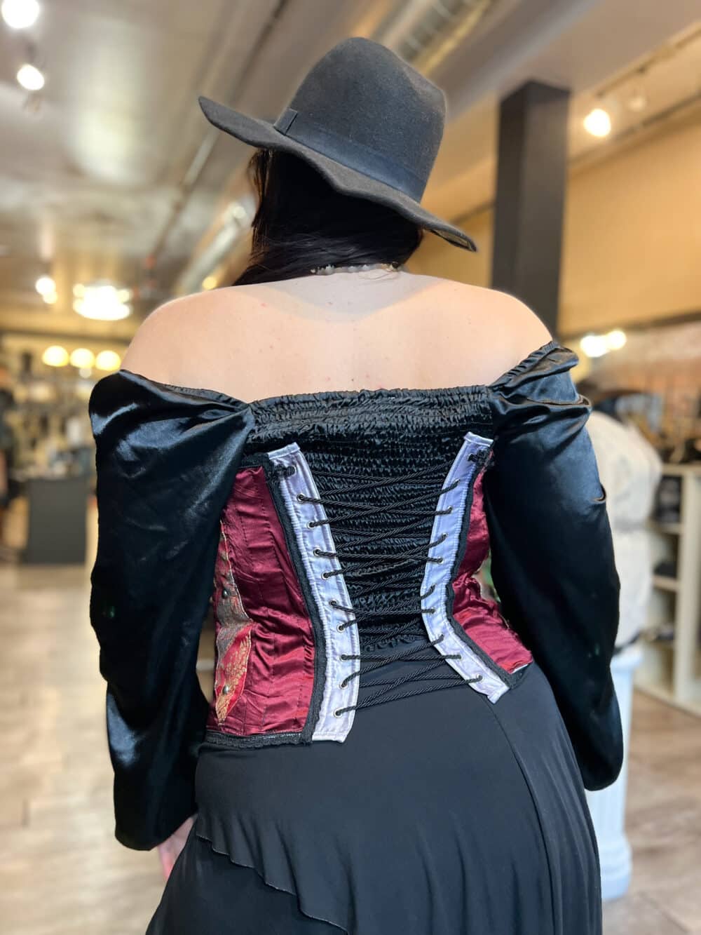 A Crimson textile renaissance bustier with paisley accents & black lace trim. Black Chord is the corset in back that helps cinch.